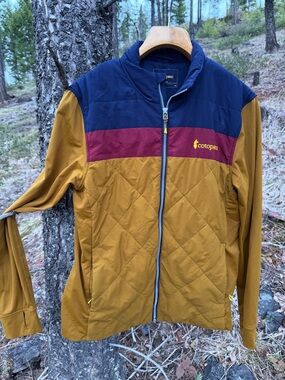 cotopaxi Navy Jacket with Gold Logo Interior